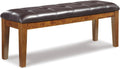 Signature Design by Ashley Ralene Tufted Upholstered Dining Room Bench, Medium Brown | Plush wipe-clean faux leather cushion, Frame of veneers, wood and engineered wood, Versatile 2-person entryway seating