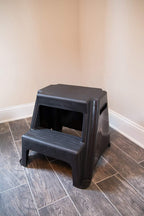 Rubbermaid 2-Step Plastic Stool, 300 lb Capacity, Lightweight, Black | Slip-resistant treads, Non-marring feet, Large standing platform, Cutout carry handles, No assembly required