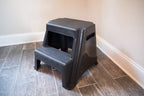 Rubbermaid 2-Step Plastic Stool, 300 lb Capacity, Lightweight, Black | Slip-resistant treads, Non-marring feet, Large standing platform, Cutout carry handles, No assembly required