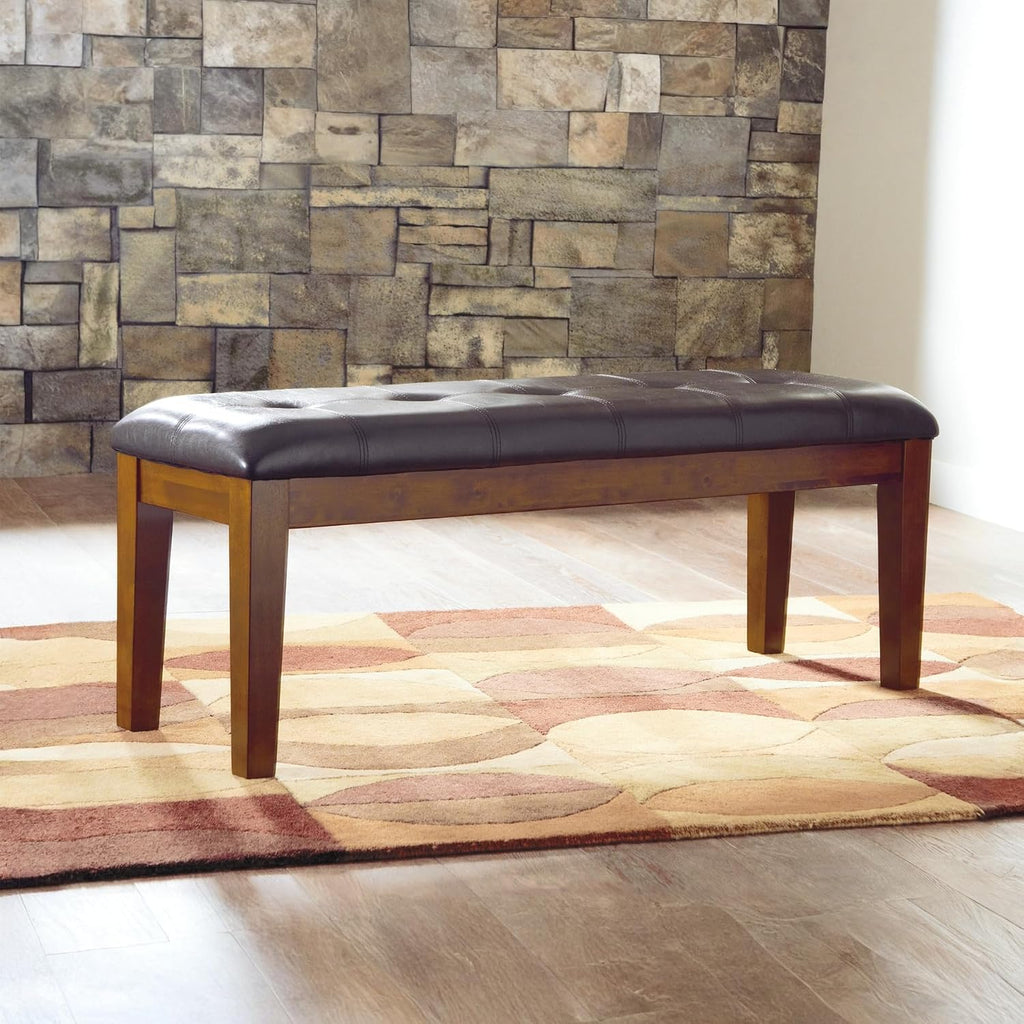 Signature Design by Ashley Ralene Tufted Upholstered Dining Room Bench, Medium Brown | Plush wipe-clean faux leather cushion, Frame of veneers, wood and engineered wood, Versatile 2-person entryway seating