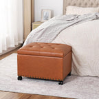 Joveco PU Leather Rolling Storage Ottoman, 24" Tufted Lid, Nailhead Trim & Hidden Storage,Elegant Footrest & Organizer on Caster Wheels for Living Room, Bedroom, Entryway(Orange Brown,Wheels)